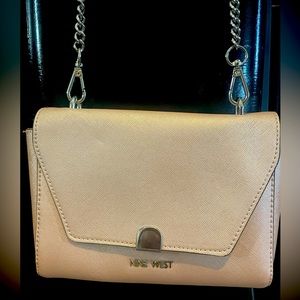This is a BRAND NEW Nine West champagne colored bag! It’s small and perfect!